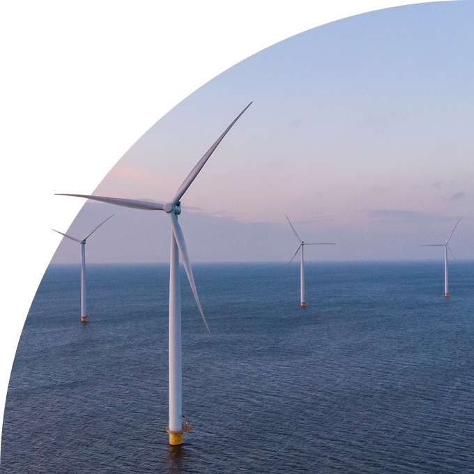 Offshore wind farm with turbines in the sea at dusk